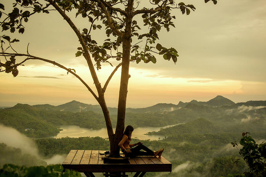 Woman Relaxing While Sitting On Observation Point During Sunset ...