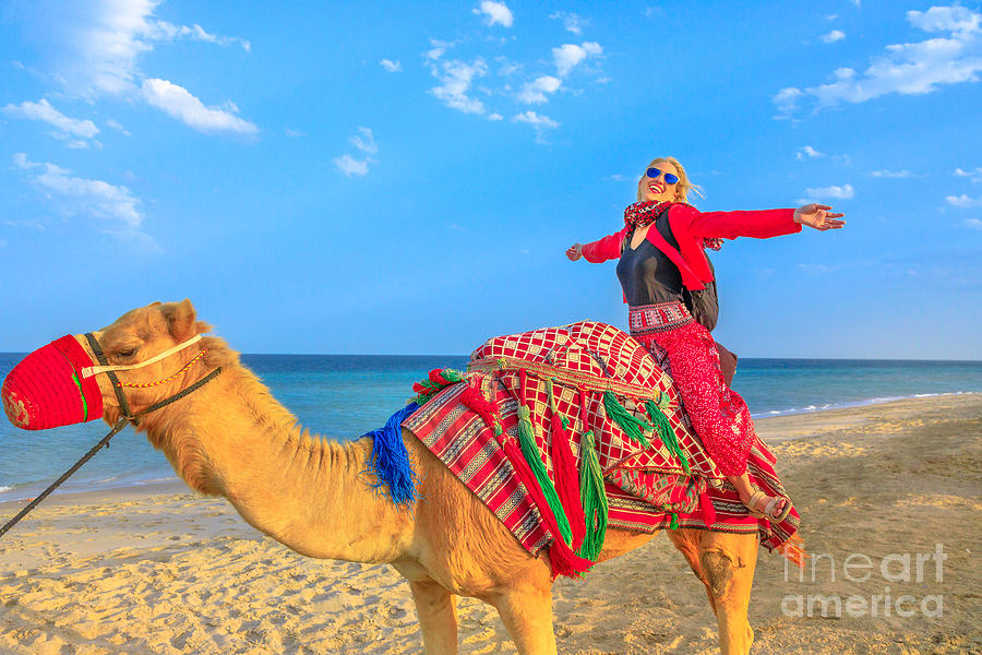 Woman riding camel Photograph by Benny Marty