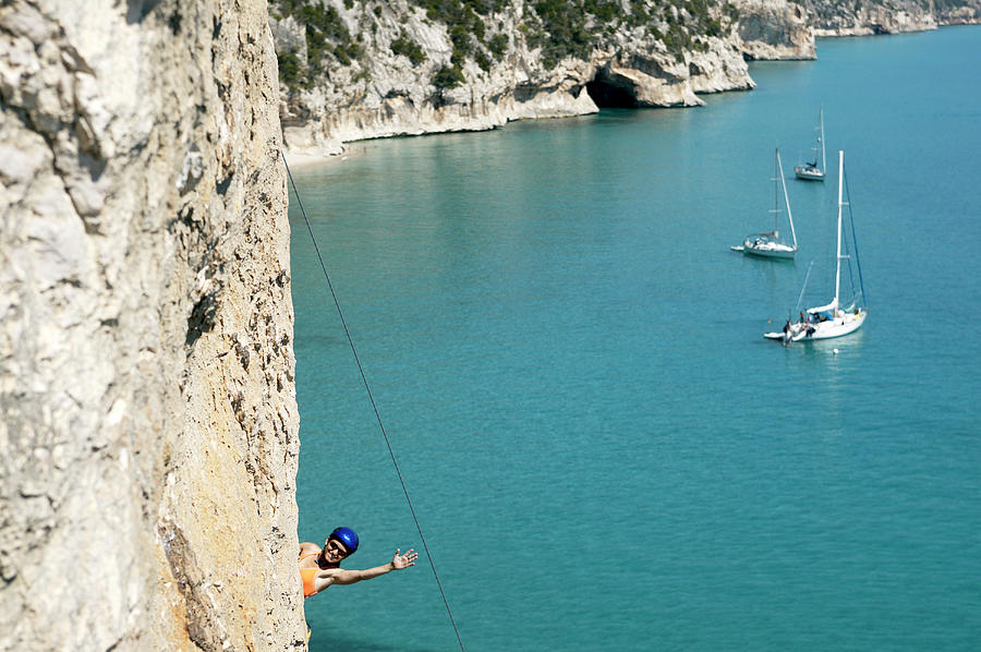 Woman Rock Climbing, Bay In Background Photograph by Ben Meyer