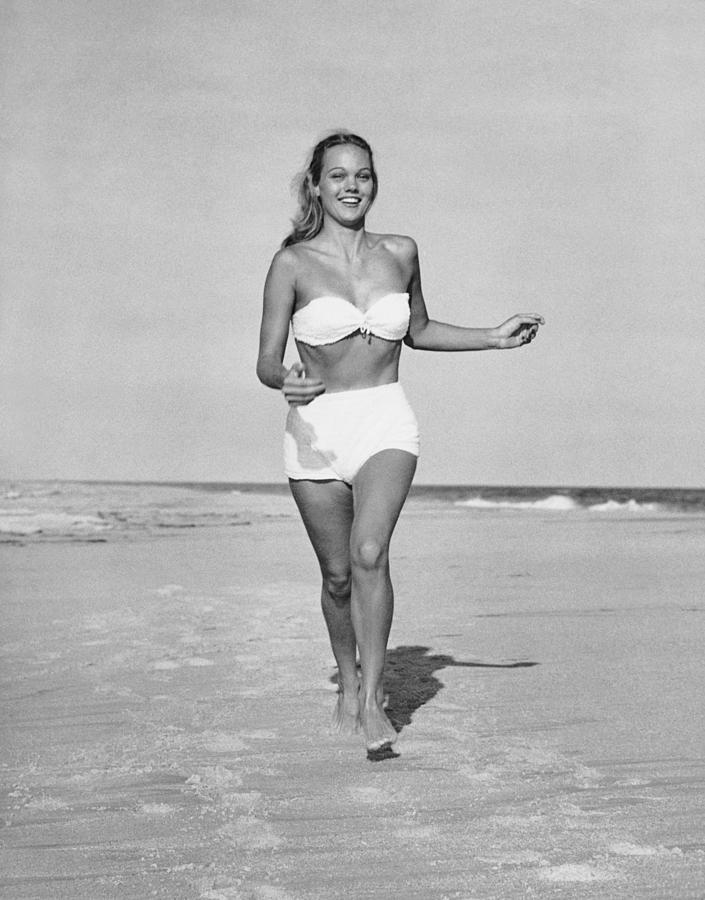 Woman Running On Beach Photograph by George Marks.