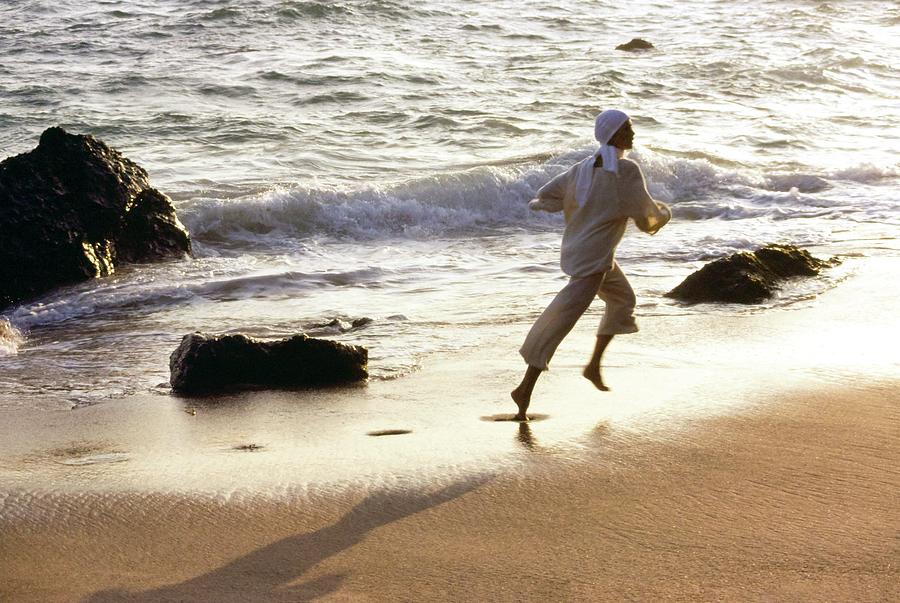 Woman Running On The Beach Photograph by Stan Malinowski