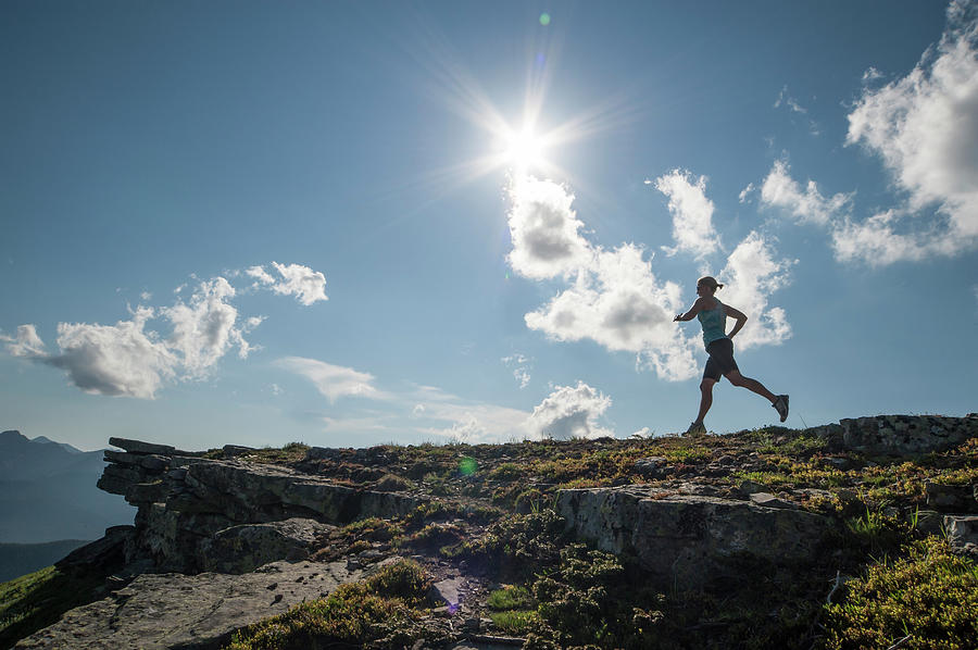 Woman Runs Along Ridge Crest, In Photograph by Ascent Xmedia