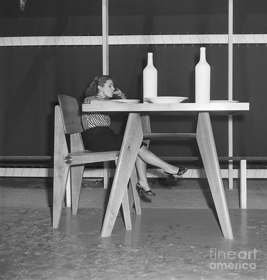 Woman Seated At Oversized Dinner Table Photograph by Bettmann