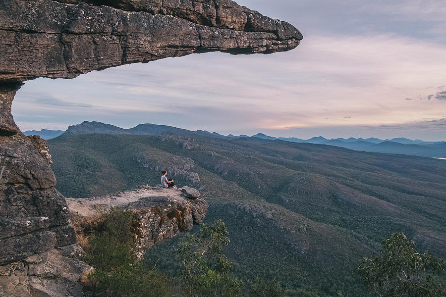 Tree Photograph - Woman Sits At The Balconies And Looks The Landscape Of The Grampians National Park, Victoria, Australia by Cavan Images