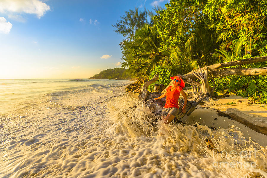 Sunset Photograph - Woman splashing wave Seychelles by Benny Marty
