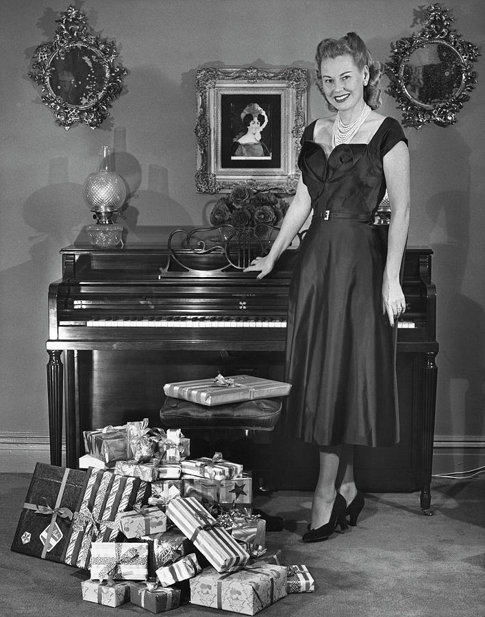 Woman Standing By Piano & Presents Photograph by George Marks