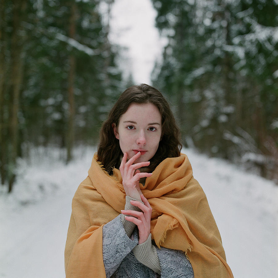 Winter Photograph - Woman Stands In A Winter Forest With A Yellow Scarf by Cavan Images