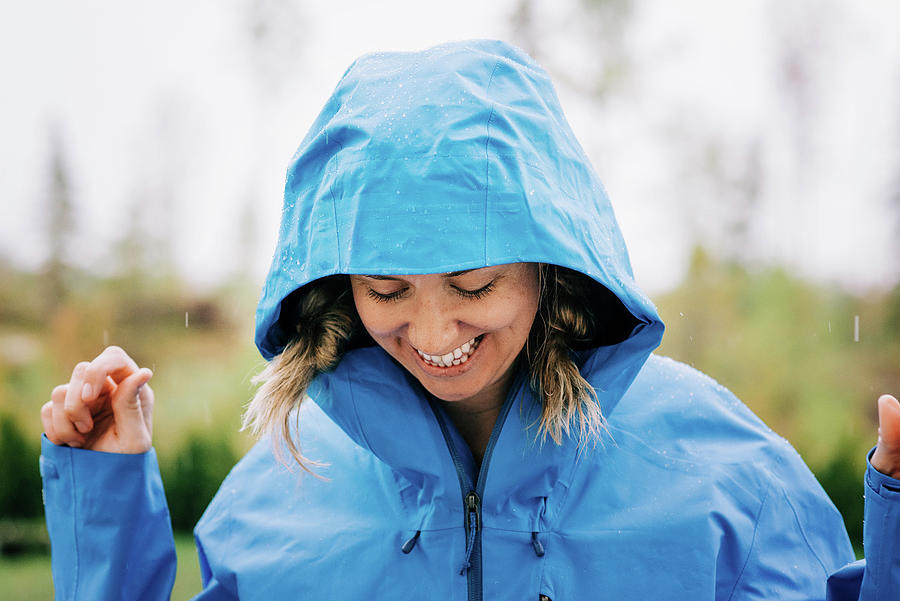 Woman Stood In The Rain Smiling Outside In A Raincoat Photograph by ...
