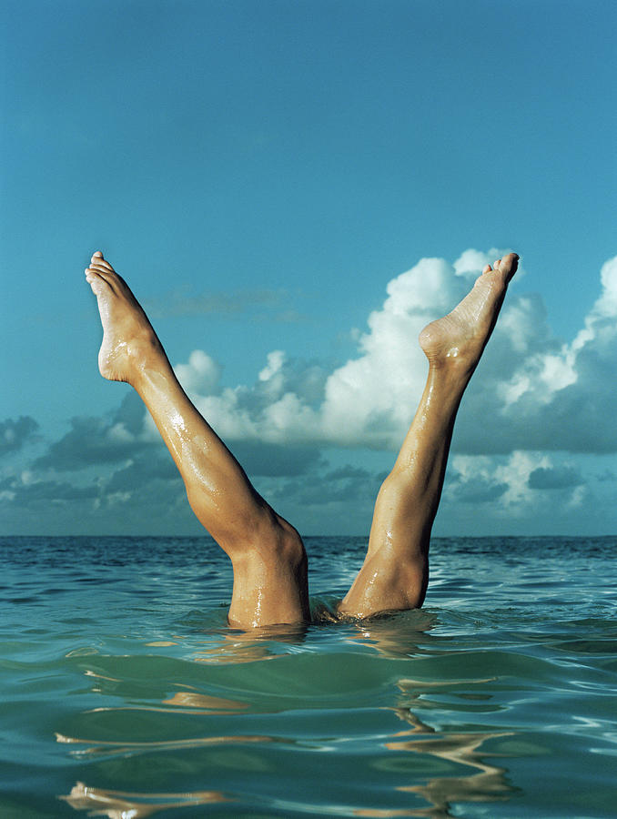 Woman Stretching Legs From Water Photograph by Matthias Clamer