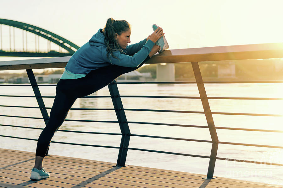 Woman Stretching On Bridge Photograph by Microgen Images/science Photo Library