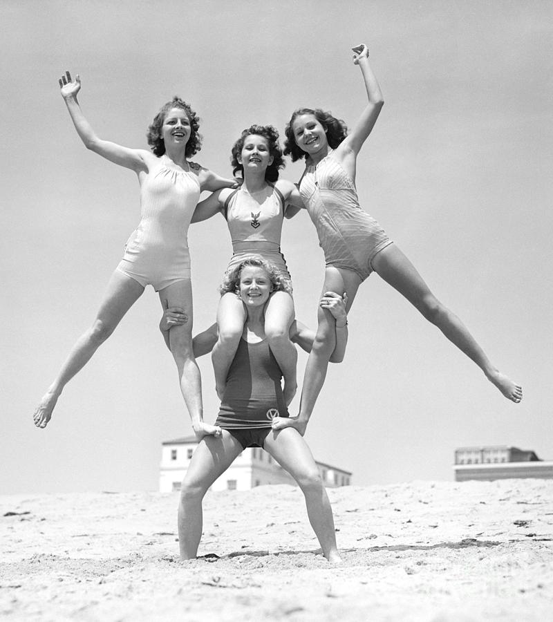 Woman Supporting Three Balancing Girls Photograph by Bettmann
