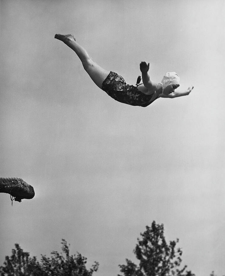 Woman Swan Diving Photograph by George Marks