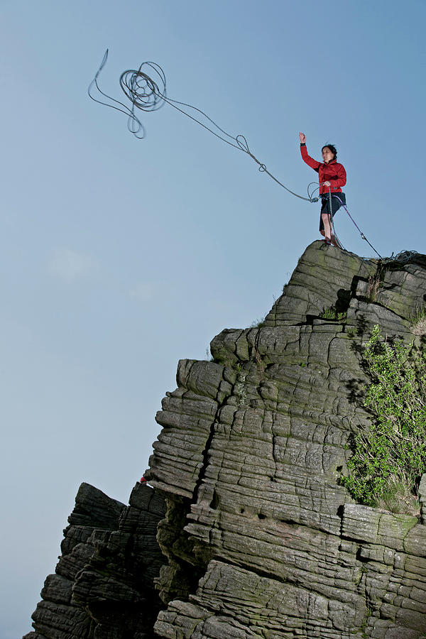 Woman Throwing Rope At Windgather Rocks In The British Peak District by  Cavan Images