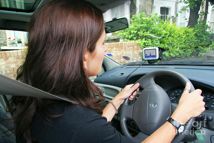 Woman Using A Satellite Navigation System Photograph by Cordelia Molloy/science Photo Library