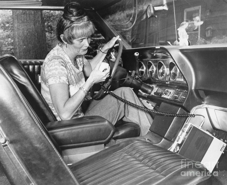 Woman Using Cb Radio In Her Car Photograph by Bettmann