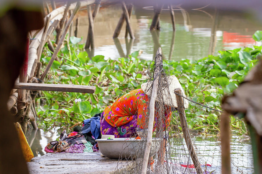 Woman Washing Clothes In Mekong River In Vietnam Photograph