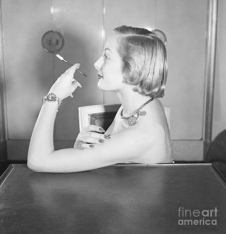 Woman Wearing Jewels And Smoking Photograph by Bettmann