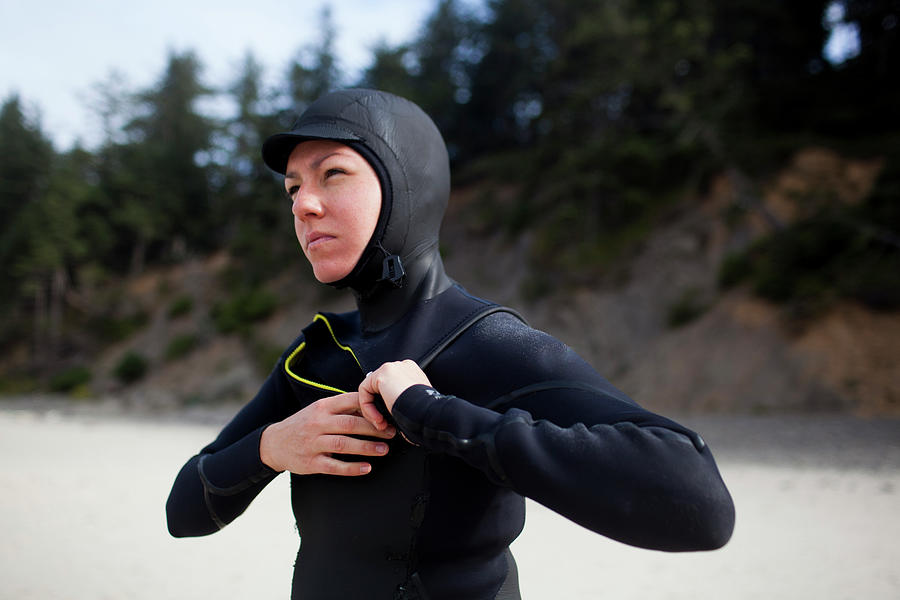 Woman Wearing Wetsuit While Standing At Beach Photograph by Cavan ...