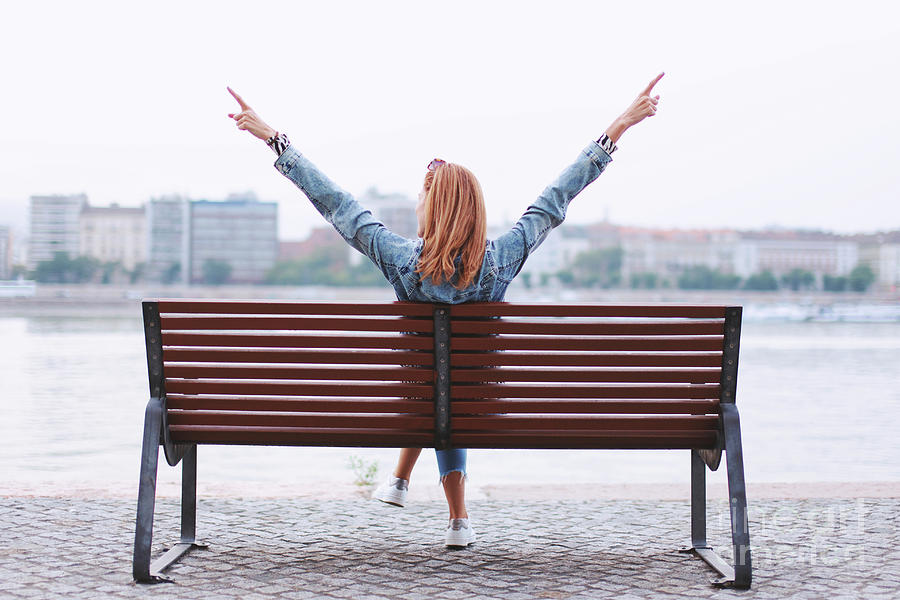 Woman With Arms Raised On Bench Photograph by Sakkmesterke/science Photo Library