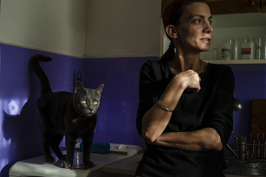 Woman With Cat In The Kitchen Photograph by Sorin Vidis