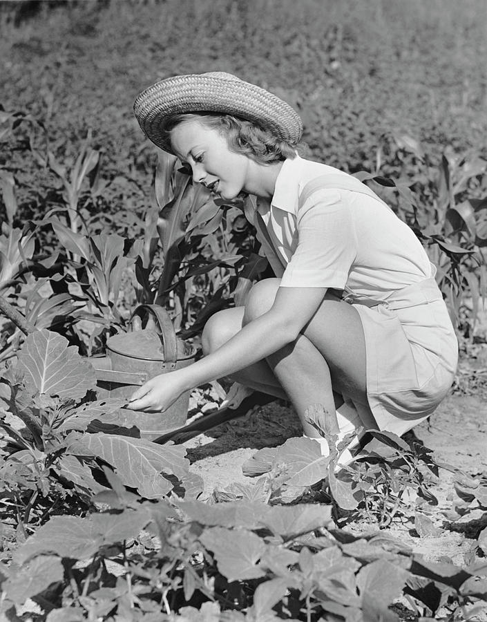 Woman Working In Garden Photograph by George Marks