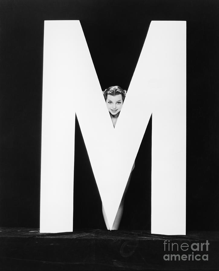 Behind Photograph - Womans Face With Huge Letter M by Everett Collection Behind Photograph - Womans Face With Huge Letter M by Everett Collection