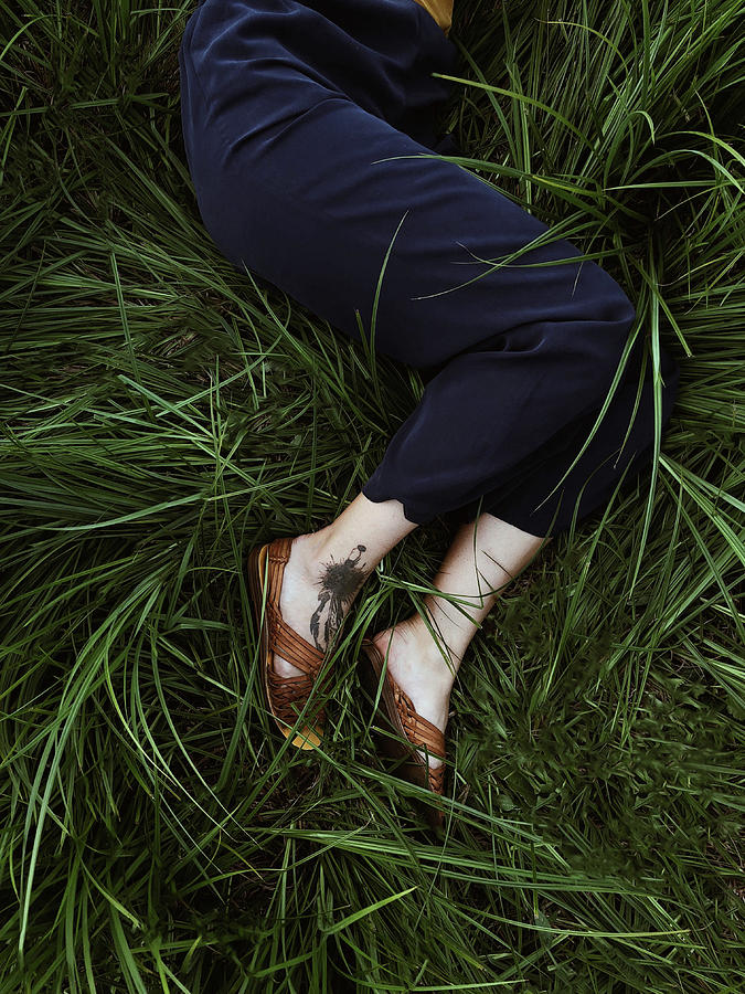 Womans Legs Lie On The Green Grass Photograph By Cavan Images Fine