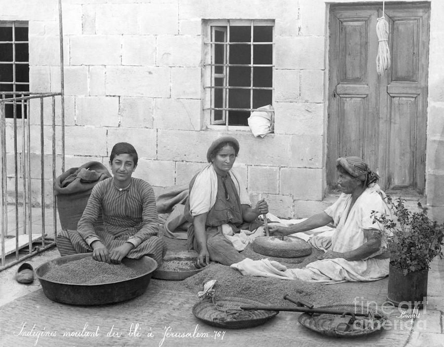 Women And Boy Grinding Grains Photograph by Bettmann
