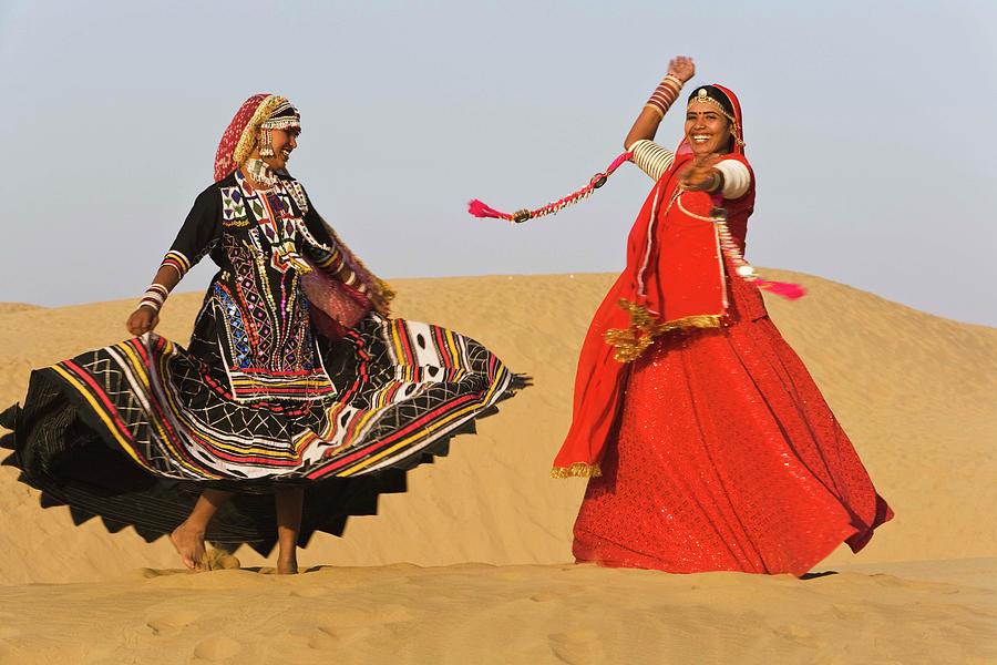 Women In Saris Dancing In Sand Photograph by Jami Tarris
