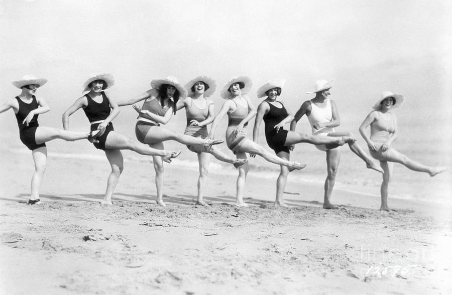 Women Kicking In Unison On The Beach Photograph by Bettmann