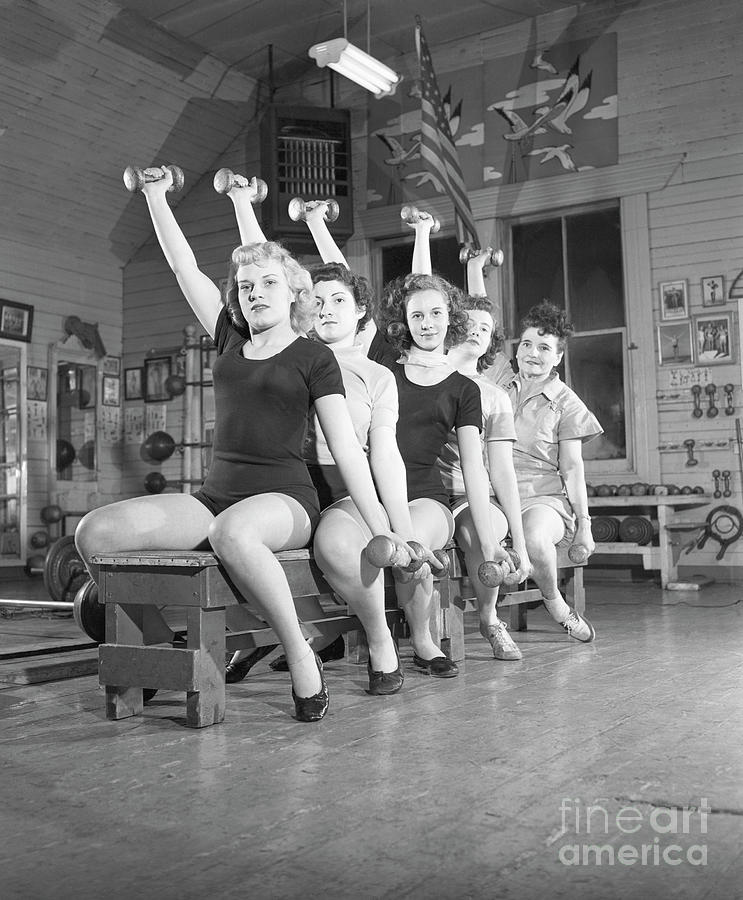 Women On Bench Exercising With Barbells Photograph by Bettmann