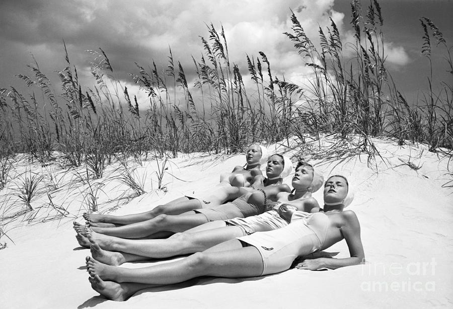 Women Sunbathing At The Beach Photograph by Bettmann