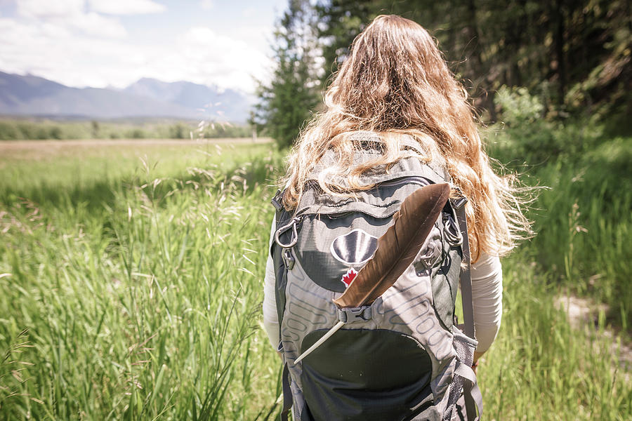 Women With Blonde Hair And Backpack With Feather Hiking In Canada ...