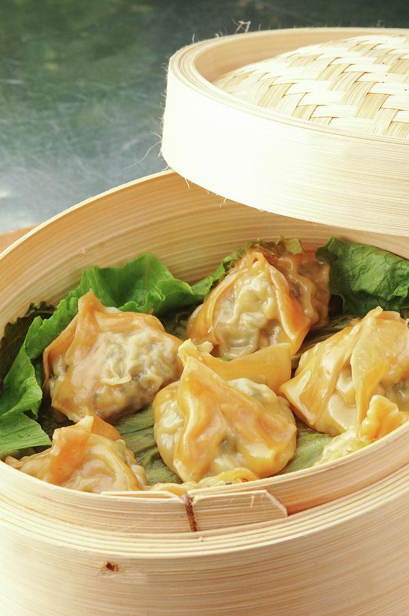 Chicken Photograph - Won Tons Filled With Thai Chicken On A Bed Of Lettuce In A Steamer Basket by John Hay