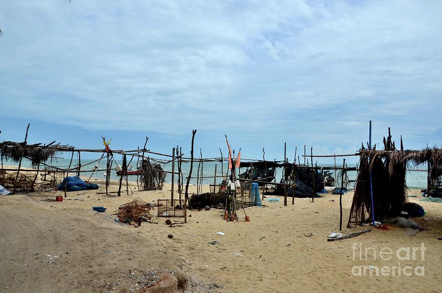 Wood and bamboo palm leaf thatched shacks by seaside in fishing village Pattani Thailand  Photograph by Imran Ahmed