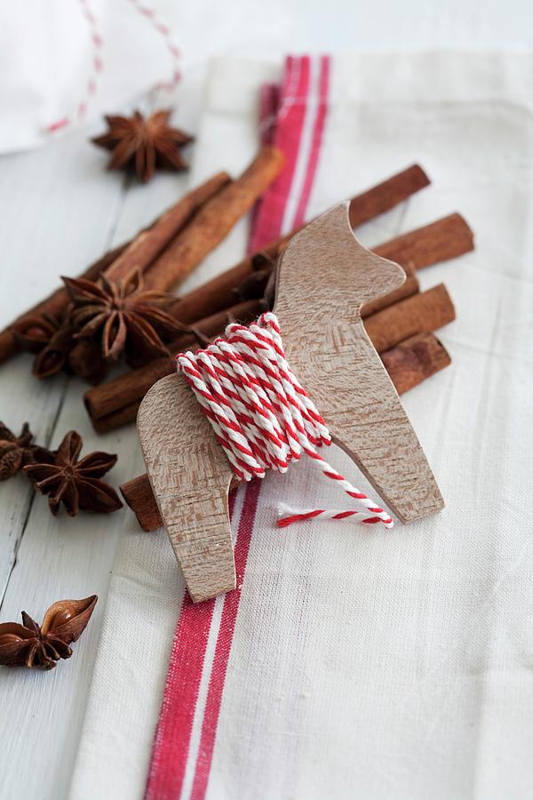 Christmas Photograph - Wooden Animal As Yarn Reel, Cinnamon Sticks And Star Anise by Martina Schindler