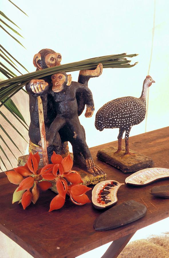 Wooden Animals And Tropical Fruit On A Wooden Bench Photograph by Guy Bouchet