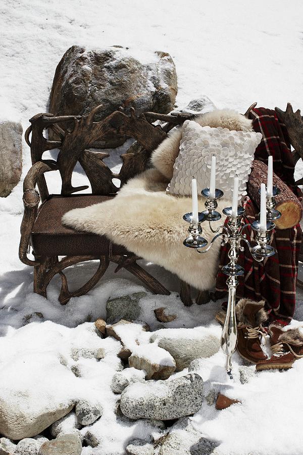 Wooden Bench With An Animal Skin And Pillows And Candlesticks In The Snow Photograph by Biglife