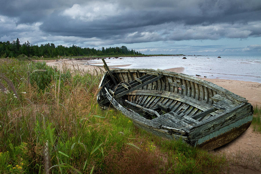 Wooden Boat lying shipwrecked on a Lake Michigan Shore Photograph by Randall Nyhof