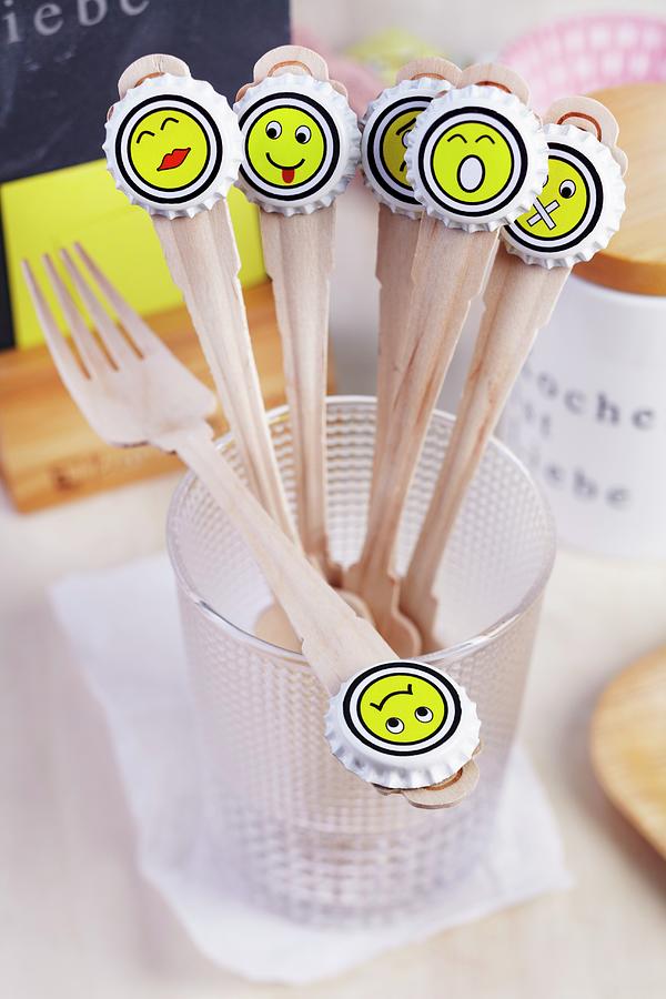 Wooden Forks With Whimsical Smiley Face Stickers On Bottle Tops Arranged Decoratively For Party Buffet Photograph by Franziska Taube