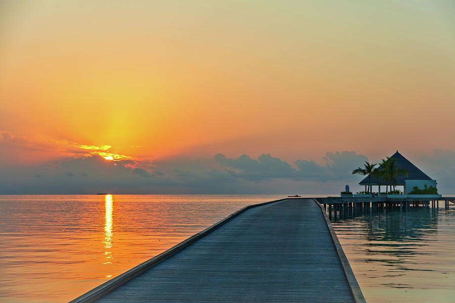 Wooden pier at tropical island resort at sunset time, Maldives ...