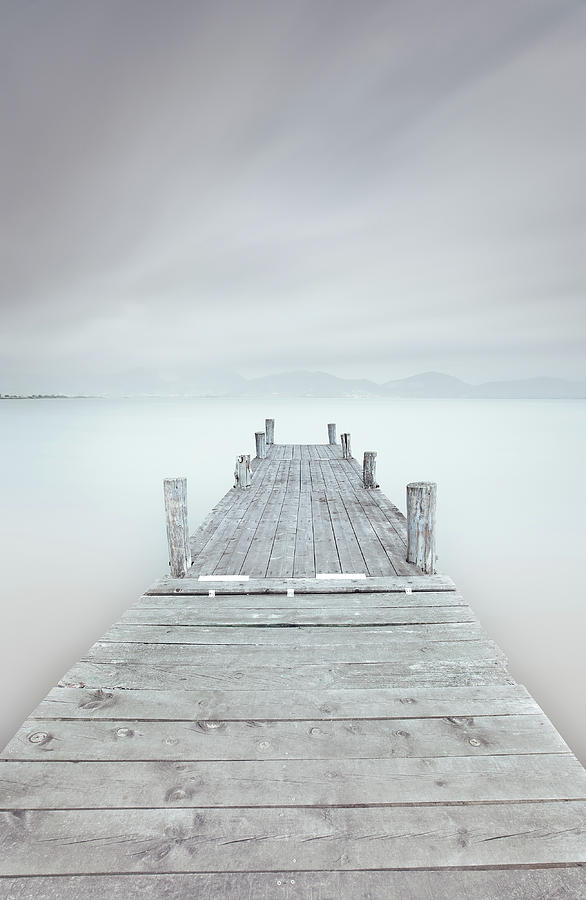 Wooden pier on lake in a cloudy and foggy mood. Photograph by Stefano Orazzini