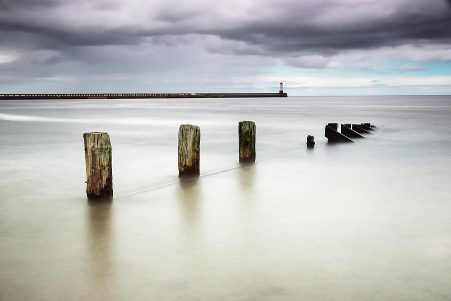 Wooden Posts In The Ocean With A Photograph by John Short / Design Pics