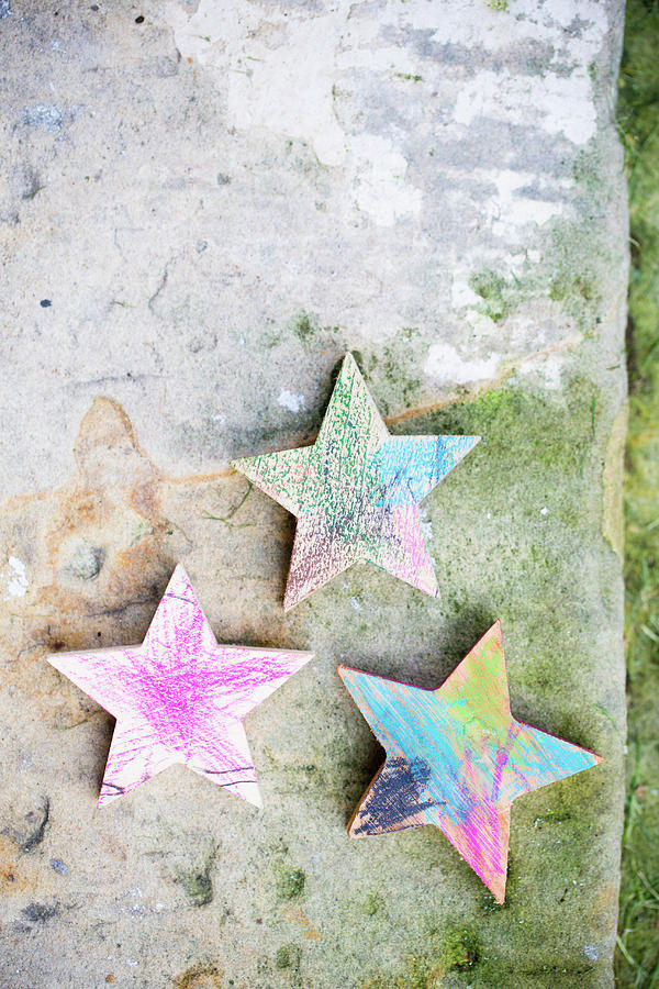Christmas Photograph - Wooden Stars Coloured In By Children by Iris Wolf