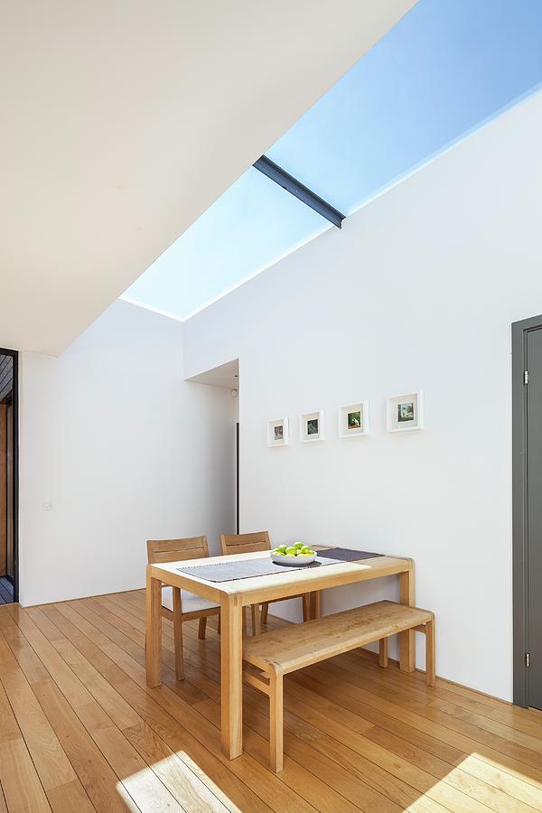 Wooden Table And Bench Set Below Skylight Photograph by Simon Maxwell Photography