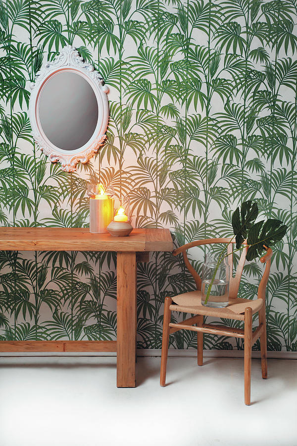 Wooden Table And Classic Chair Against Leaf-patterned Wallpaper Photograph by Great Stock!