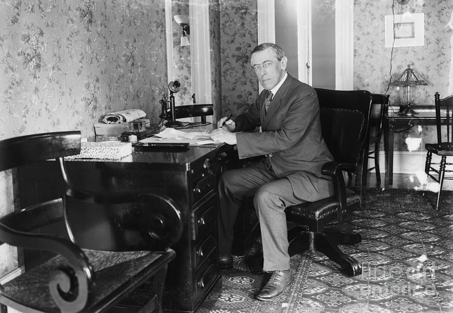 Woodrow Wilson Seated At Desk Photograph by Bettmann
