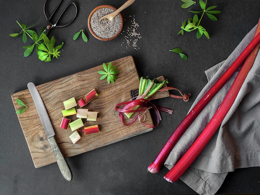 Woodruff And Chia Seeds Behind A Wooden Board With Chopped Rhubarb Photograph by Freiknuspern