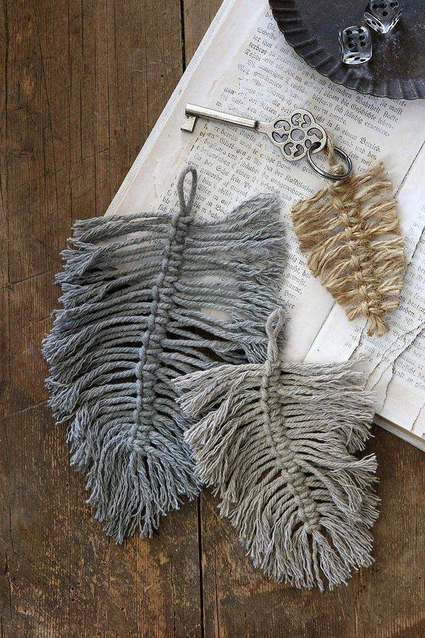 Woollen Macrame Feathers Used As Key Pendants On Old Book Photograph by Regina Hippel