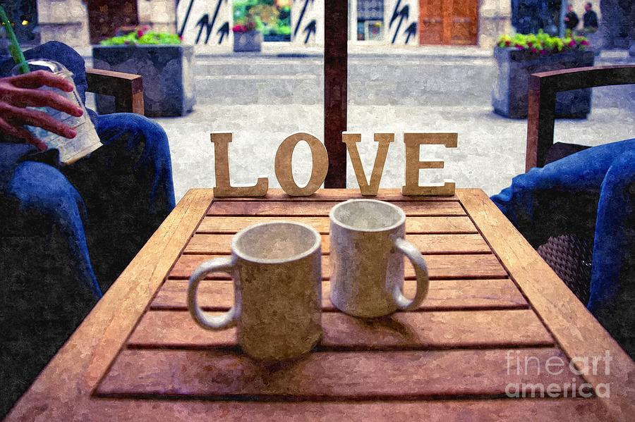 Word Love next to two cups of coffee on a table in a cafeteria,  Photograph by Joaquin Corbalan